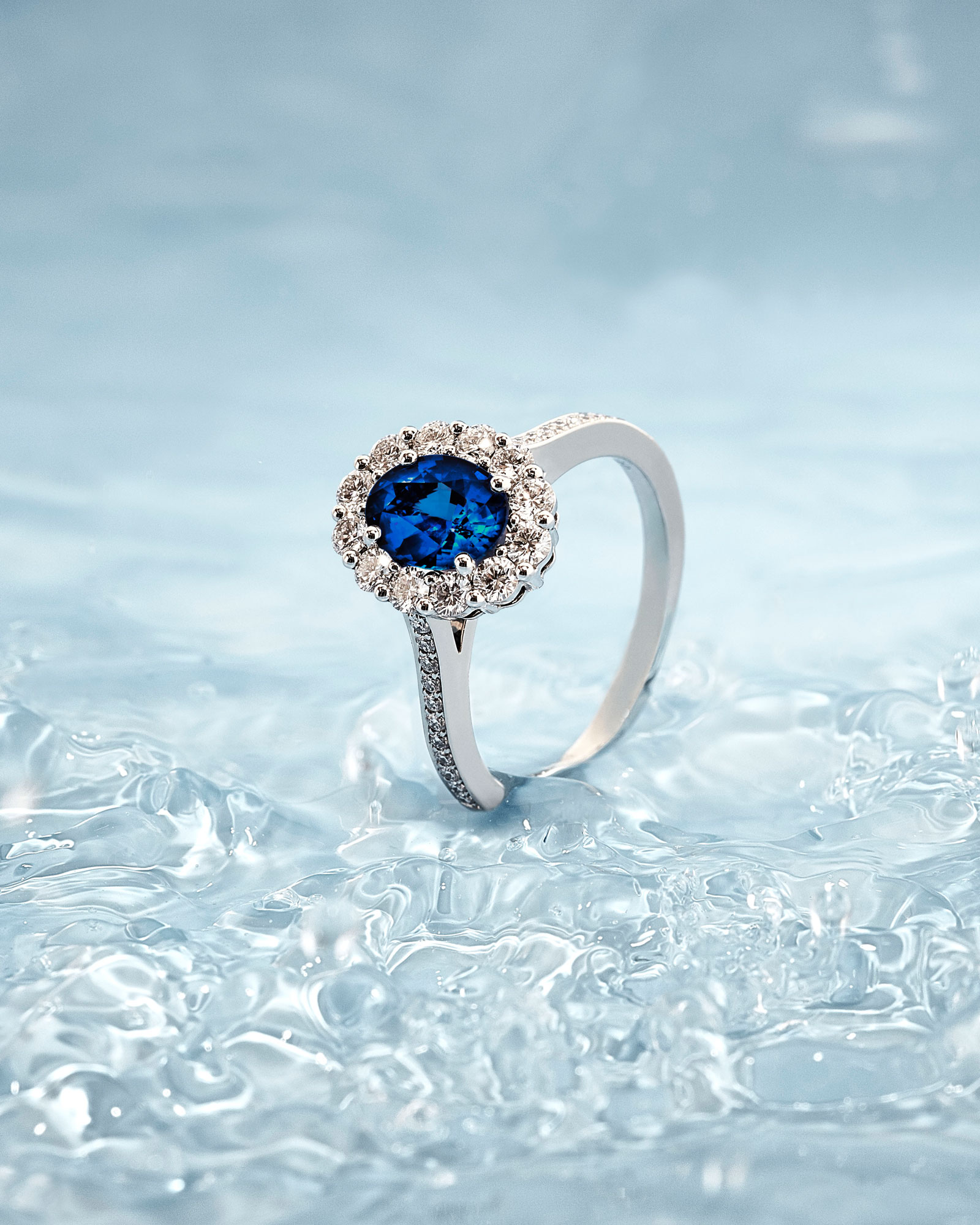 Close up of a Garrard Jewelled Vault Oval Royal Blue Sapphire and Diamond Cluster High Jewellery Ring portrait