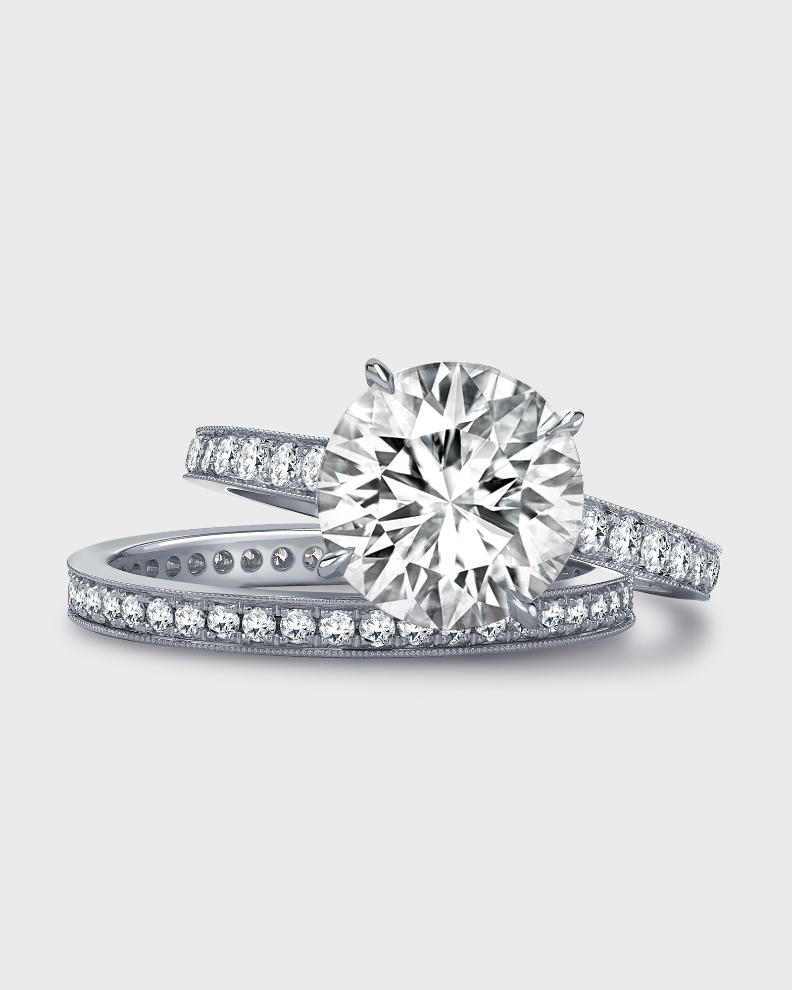 Close up of a Garrard bridal jewellery collection diamond wedding bands and a round diamond engagement ring
