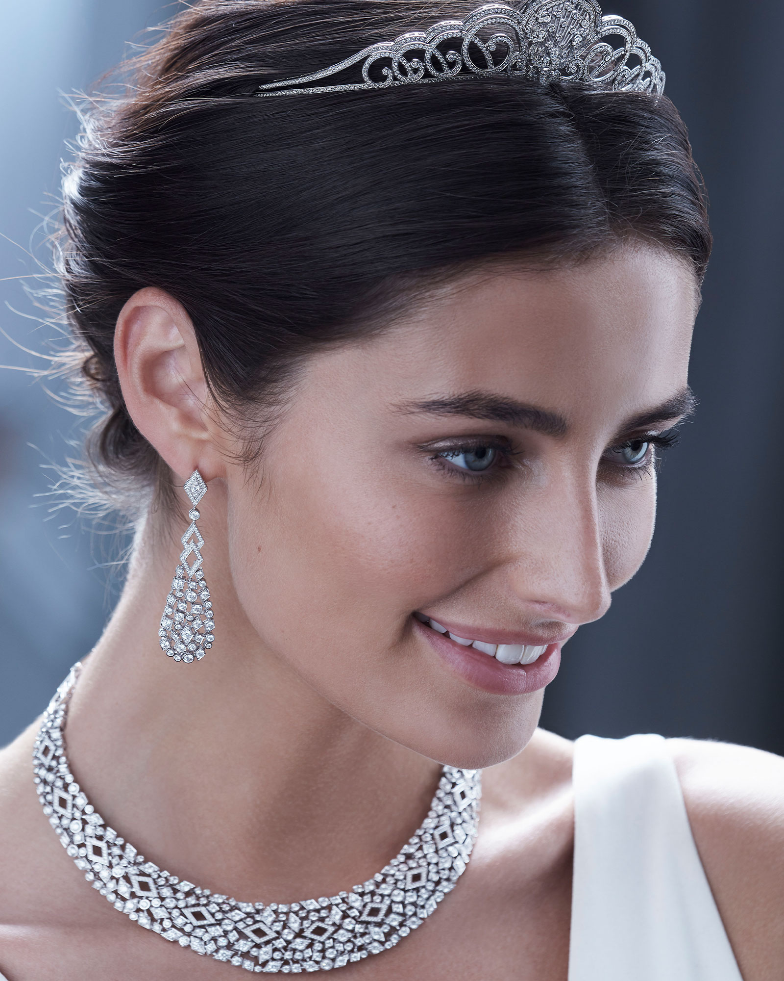 Close up of a bride wearing Garrard Bridal collection diamond tiara necklace and earrings mobile