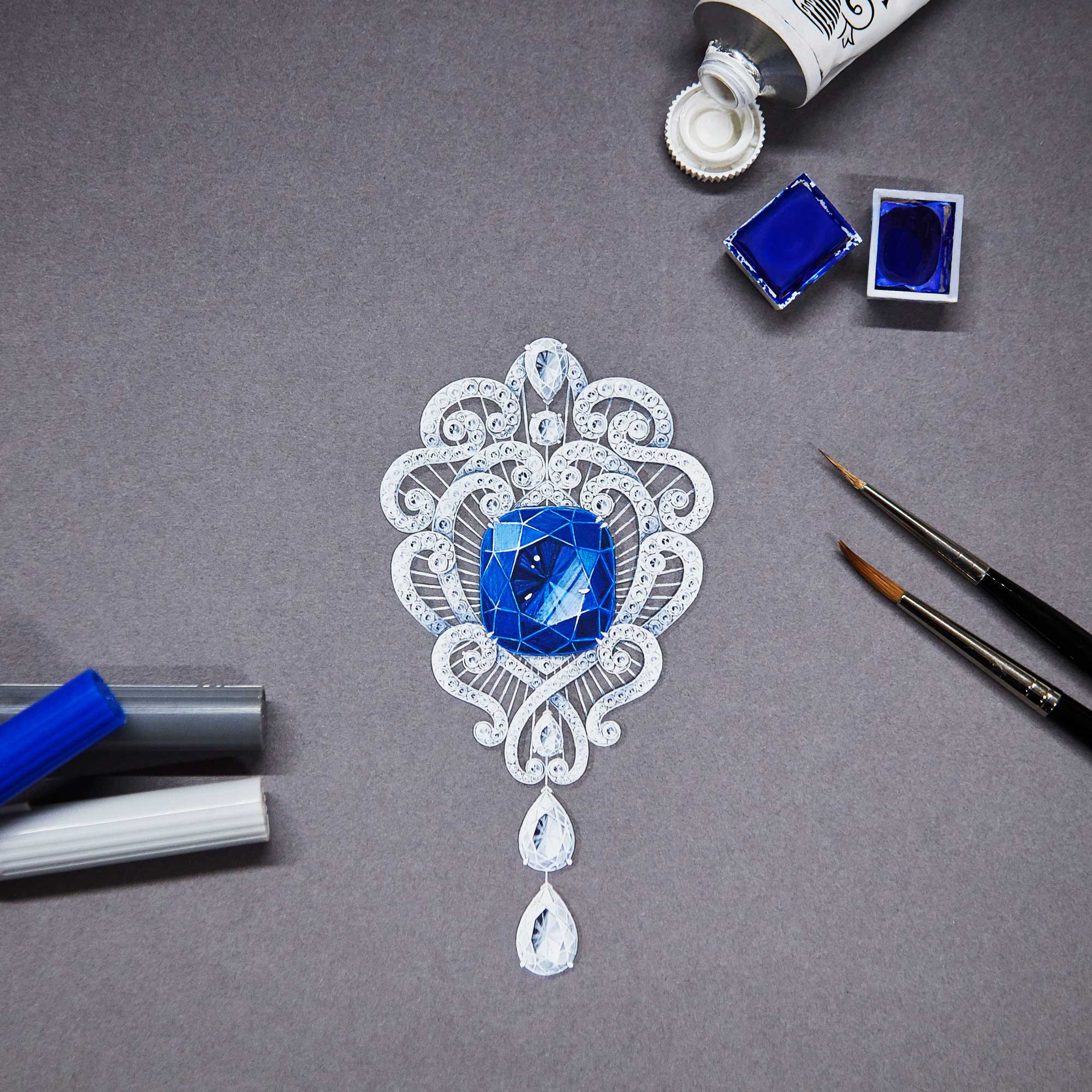 Close up of a gouache painting of a sapphire and diamond brooch at Garrard design workship