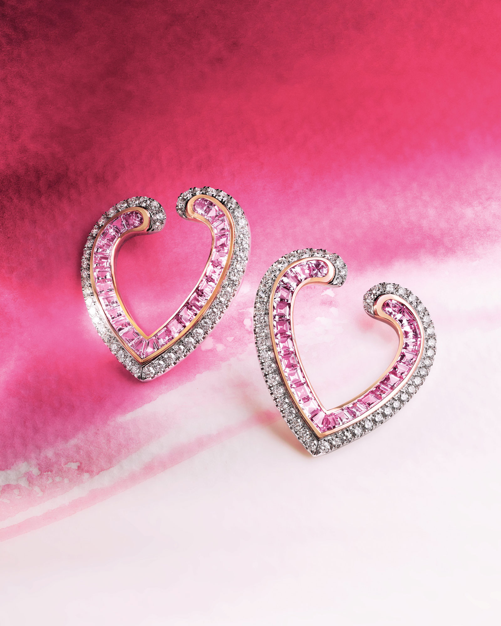 Close up of a pair of Aloria Calibre Cut Pink Sapphire Earrings In 18ct White and Rose Gold with Diamonds from Garrard vertical