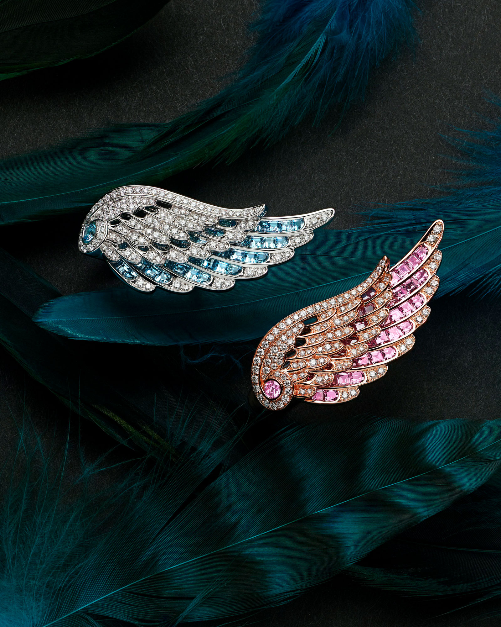 Close up of two Wings Embrace Across the Finger Diamond Ring set with Aquamarine and Pink Sapphire on feathers vertical