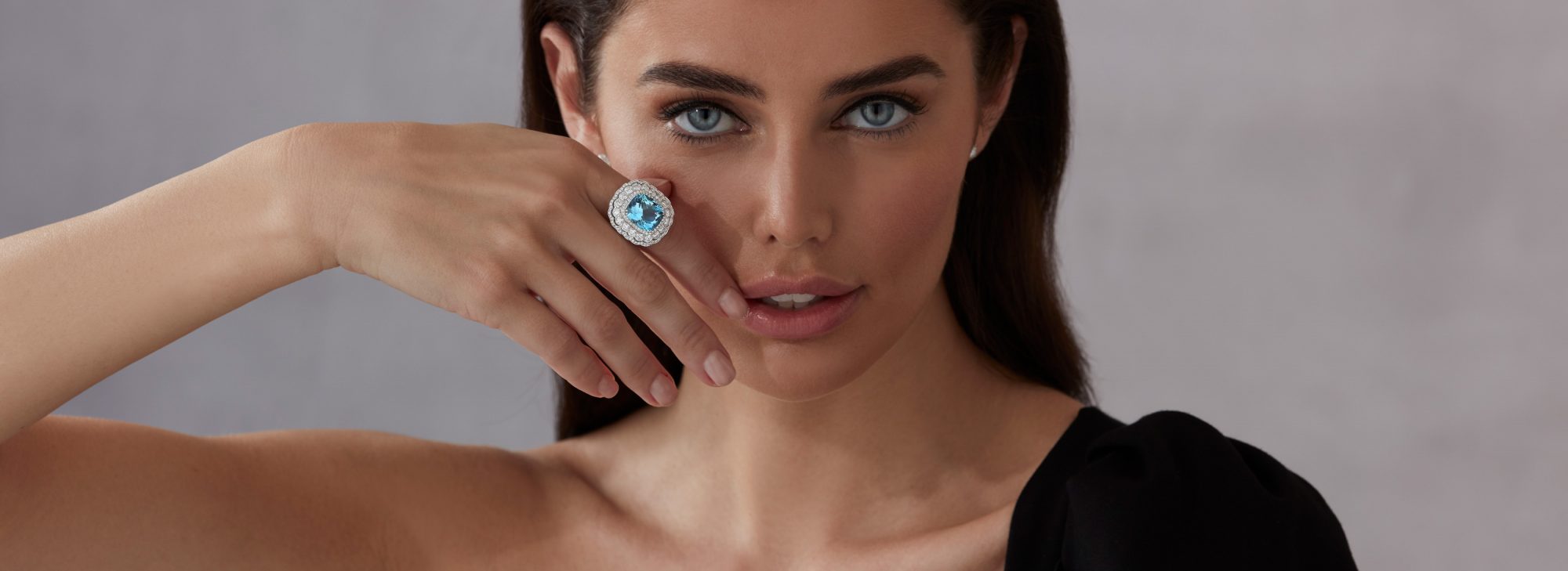 Model wears Garrard high jewellery Jewelled Vault aquamarine and diamonds ring and diamond earrings