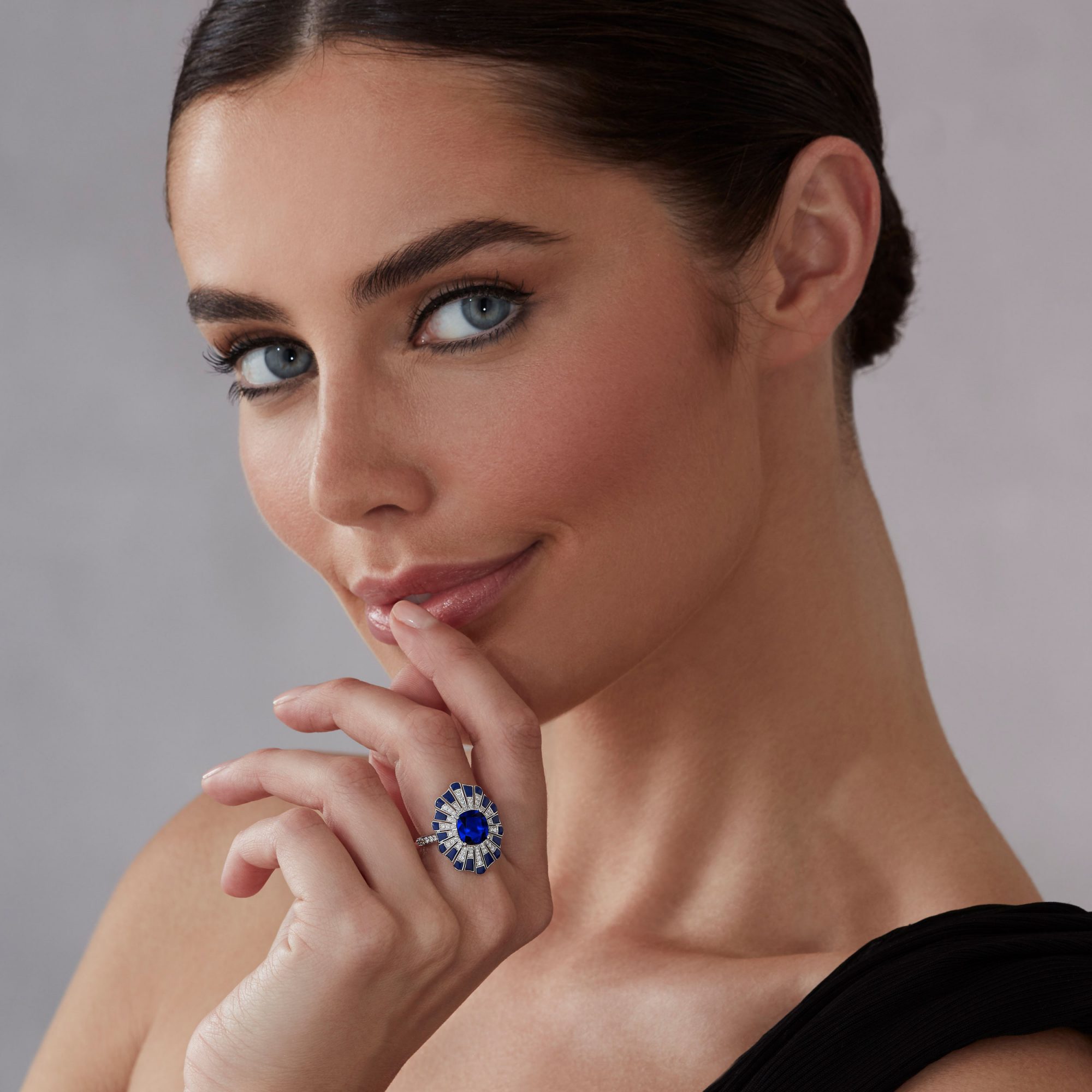 Model wears Garrard high jewellery collection jewelled vault sapphire and diamond ring 1