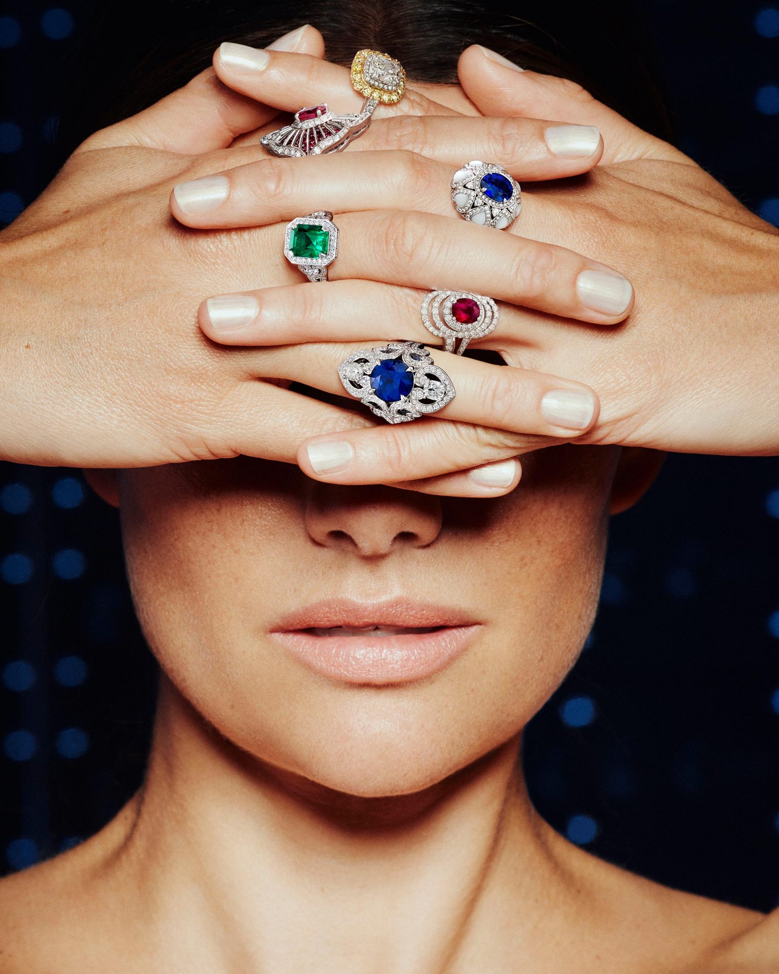 a woman wearing 6 Garrard Jewelled Vault Gemstone rings