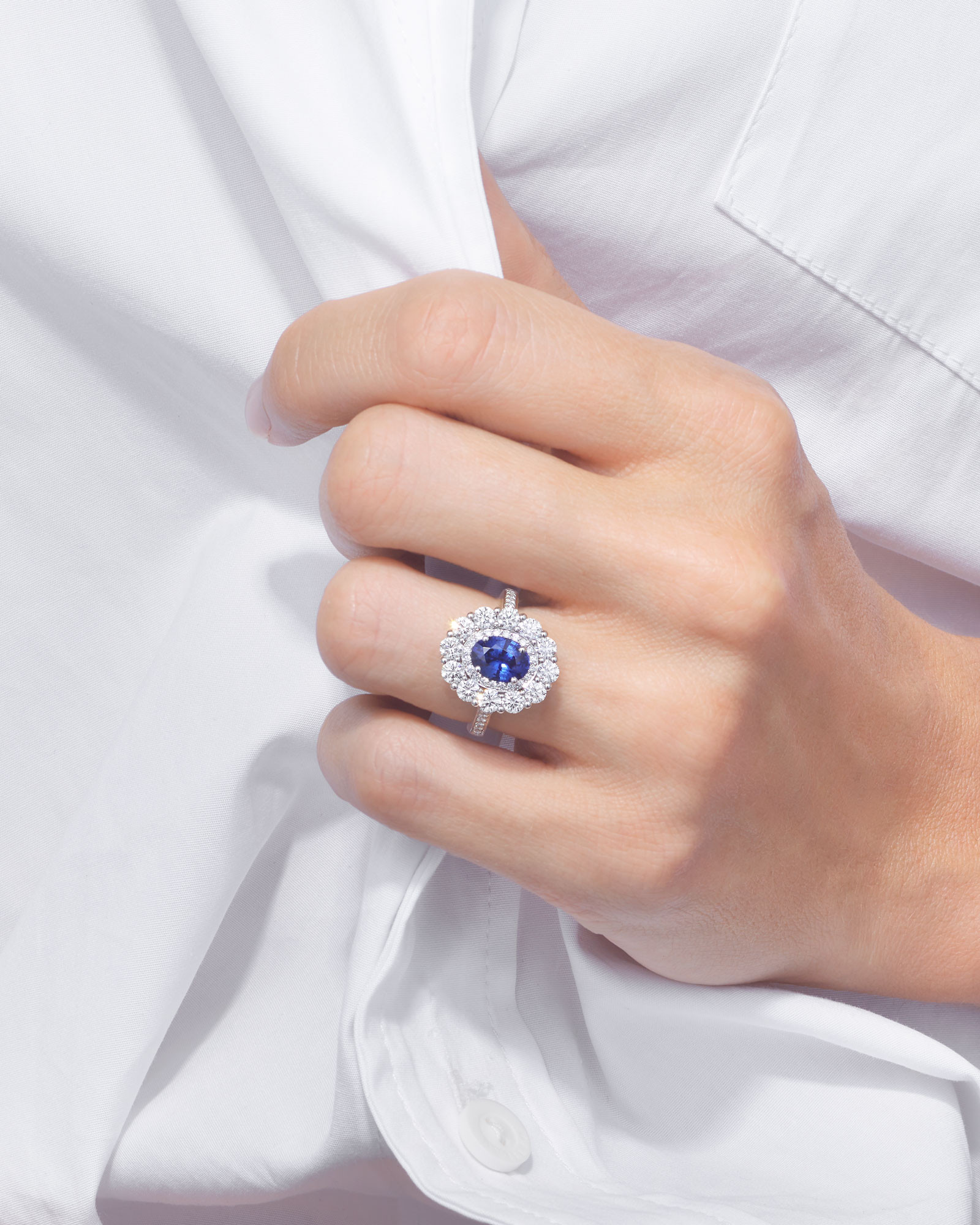a woman wearing a stacked Garrard sapphire 1735 ring on her left wedding finger vertical
