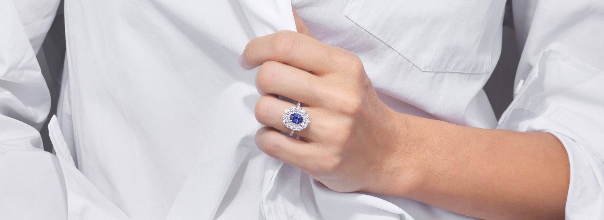 a woman wearing a stacked Garrard sapphire 1735 ring on her left wedding finger desktop