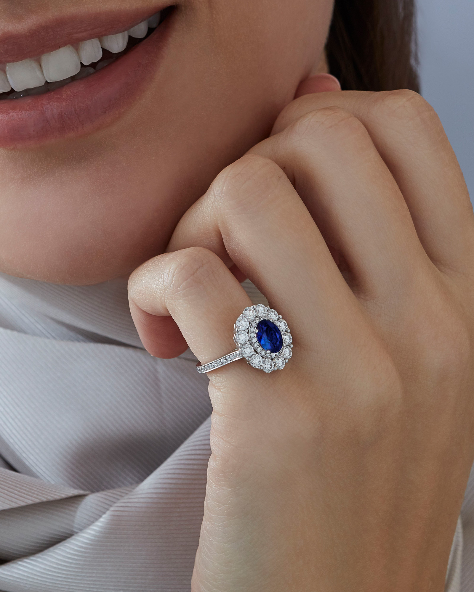 Close up of a Garrad 1735 collection sapphire and diamond ring on a model