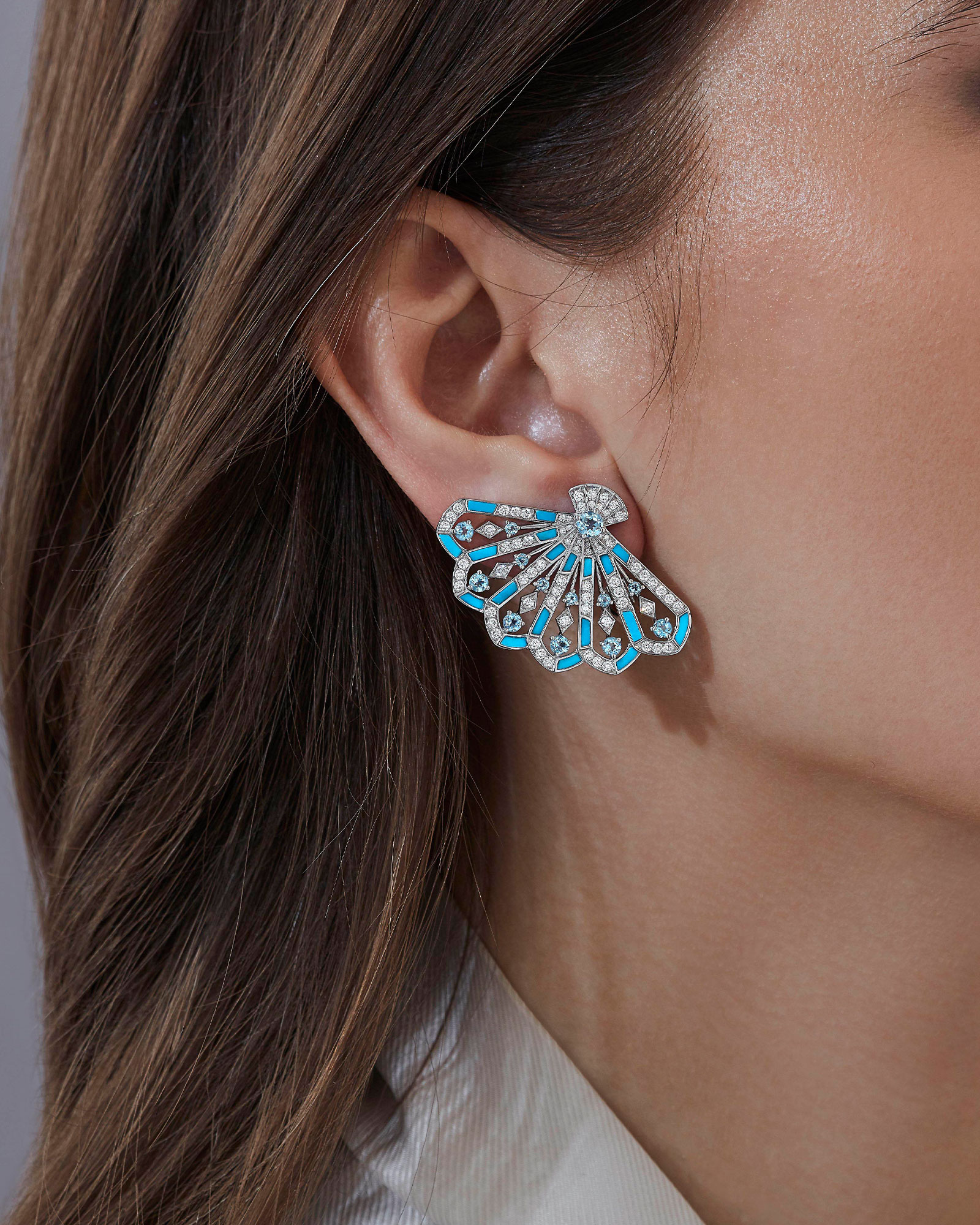 Close up of a Garrad Fanfare collection diamond earring on a model