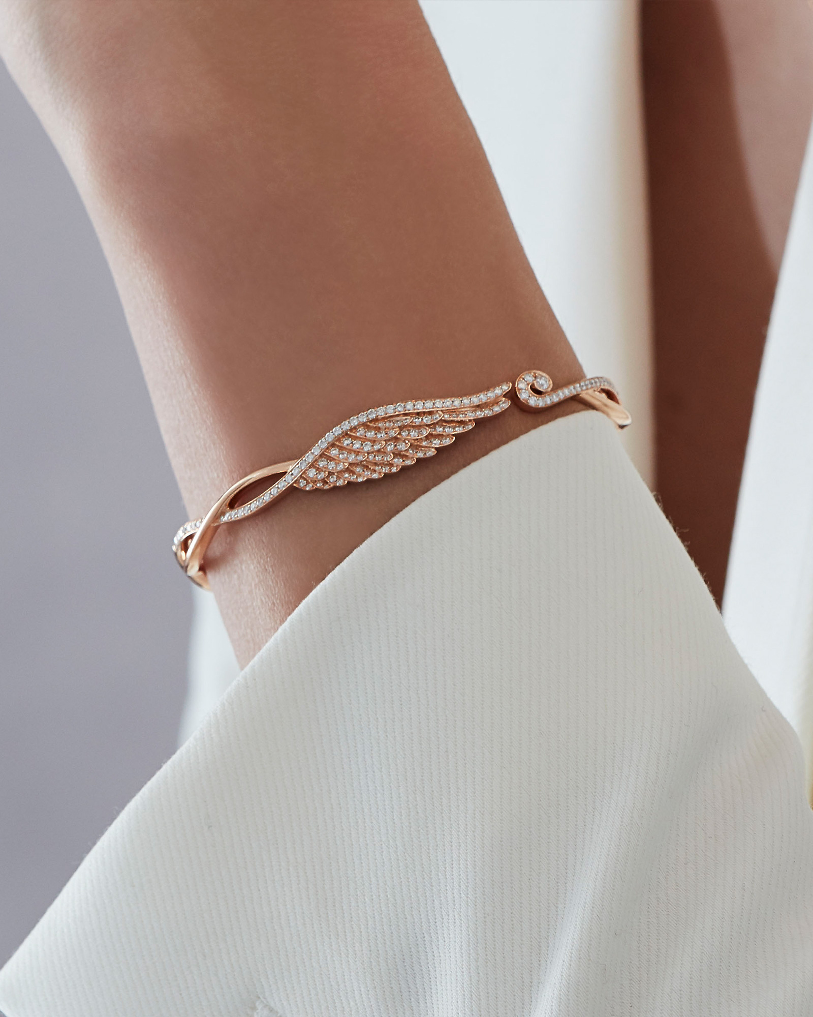 Close up of a Garrad Wings collection diamond bangle on a model