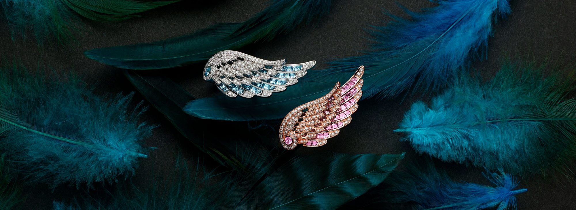 Close up of two Wings Embrace Across the Finger Diamond Ring set with Aquamarine and Pink Sapphire on feathers