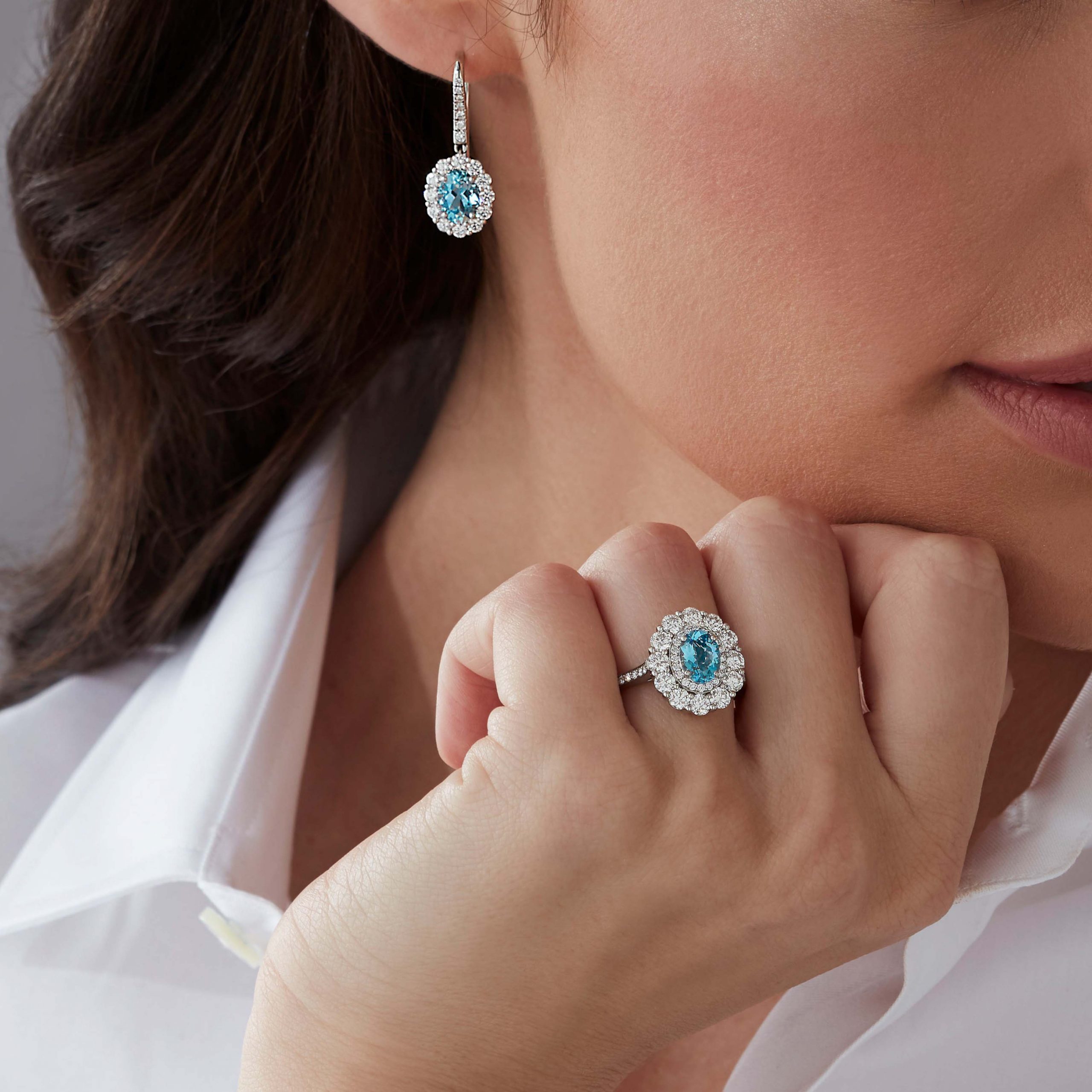 Garrard 1735 jewellery collection Aquamarine Double Cluster Ring In Platinum with Diamonds JR17PT11 and earrings on model Garrard 1735 jewellery collection Aquamarine Double Cluster Ring In Platinum with Diamonds JR17PT11 and earrings on model