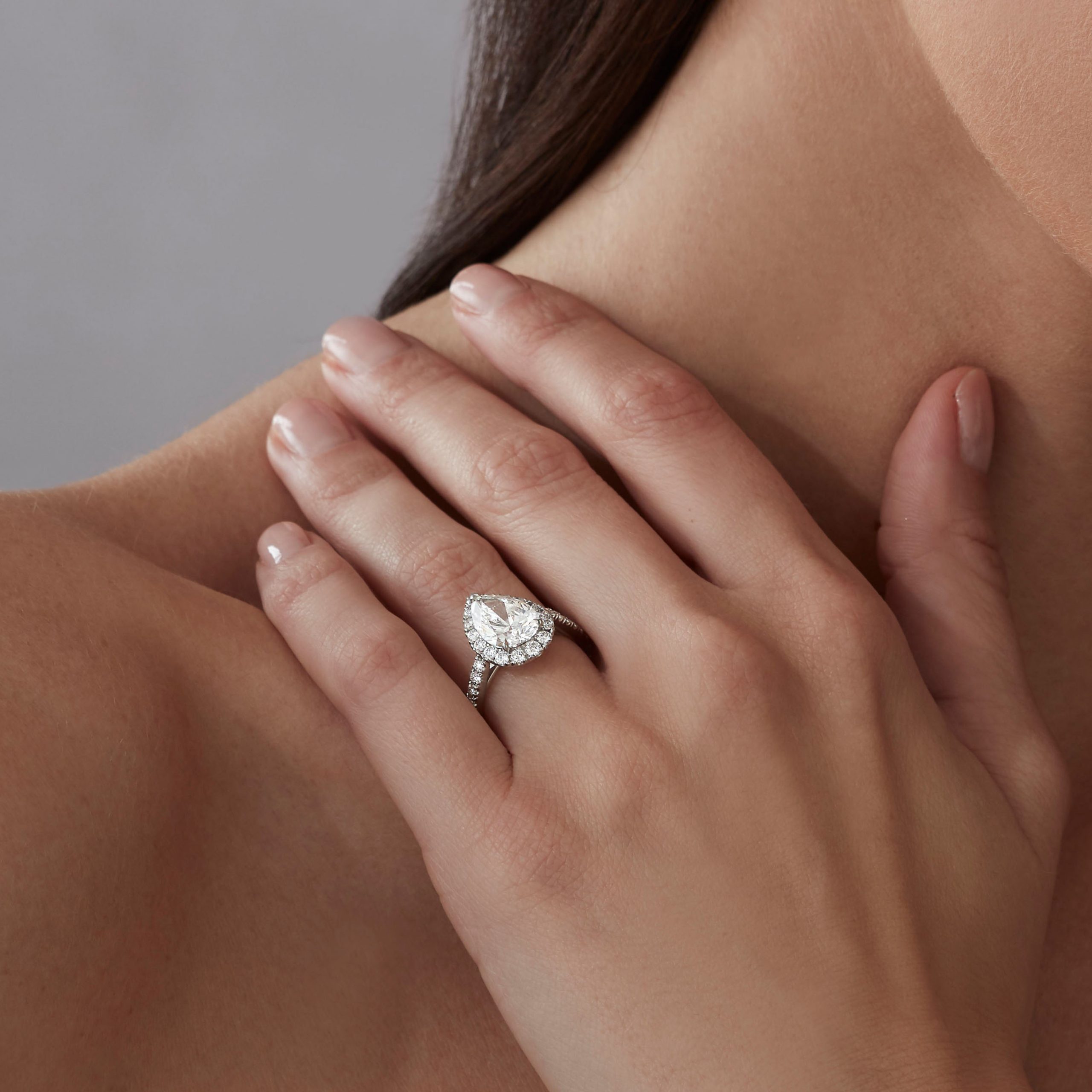Garrard Bridal collection Evermore Pear Shape Diamond Halo Engagement Ring In Platinum with Diamonds JREVPT01 2015375 on model Garrard Bridal collection Evermore Pear Shape Diamond Halo Engagement Ring In Platinum with Diamonds JREVPT01 2015375 on model