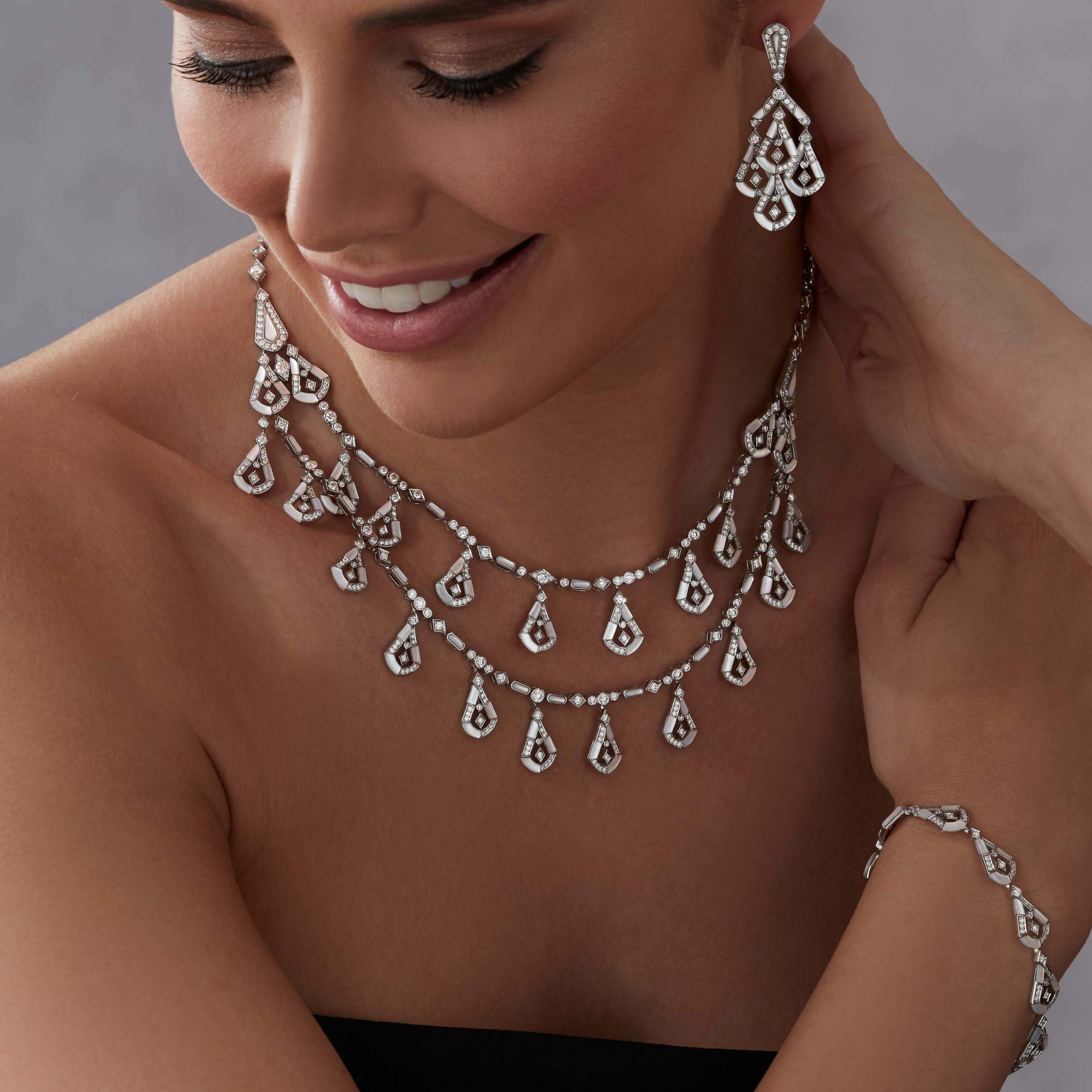 Garrard Fanfare Symphony High Jewellery Diamond and Mother of Pearl Necklace In 18ct White Gold 2017276 earrings 2017277 and bracelet 2017290 on model Garrard Fanfare Symphony High Jewellery Diamond and Mother of Pearl Necklace In 18ct White Gold 2017276 earrings 2017277 and bracelet 2017290 on model