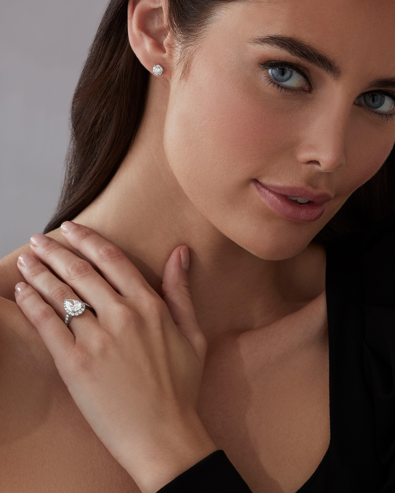 Model wears Garrard bridal collection diamond earrings and engagement ring