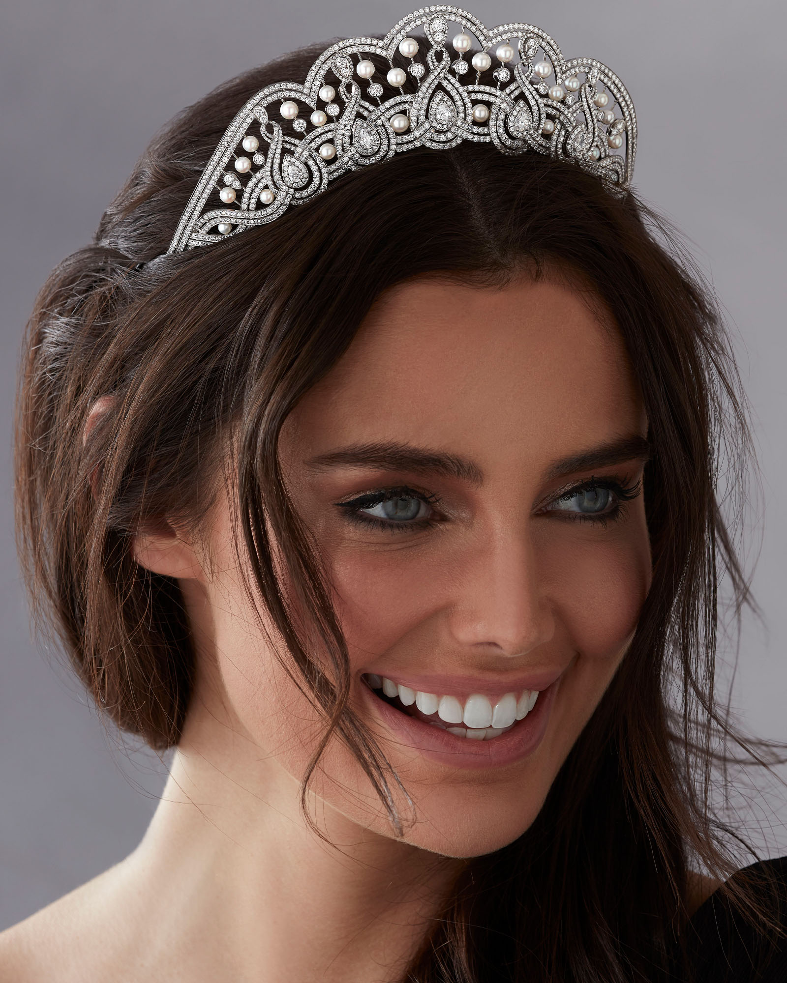 Model wears Garrard high jewellery collection diamond and pearl tiara close up
