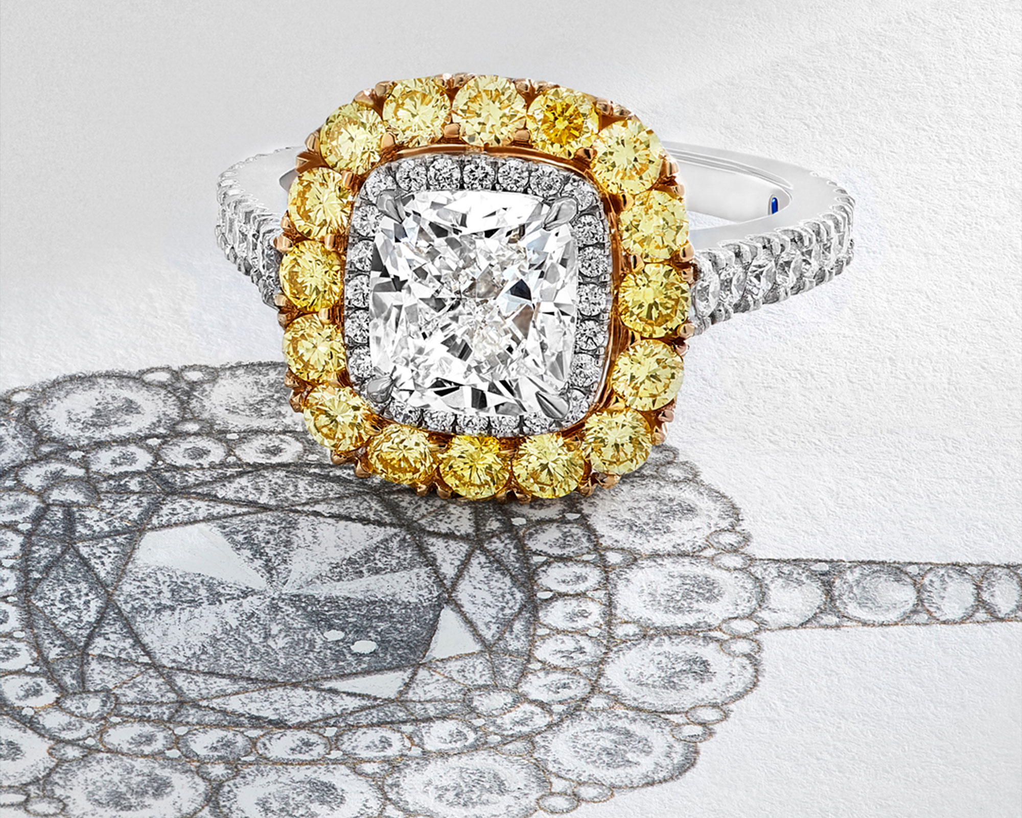 close up of a white and yellow Garrard engagement ring on the sketch