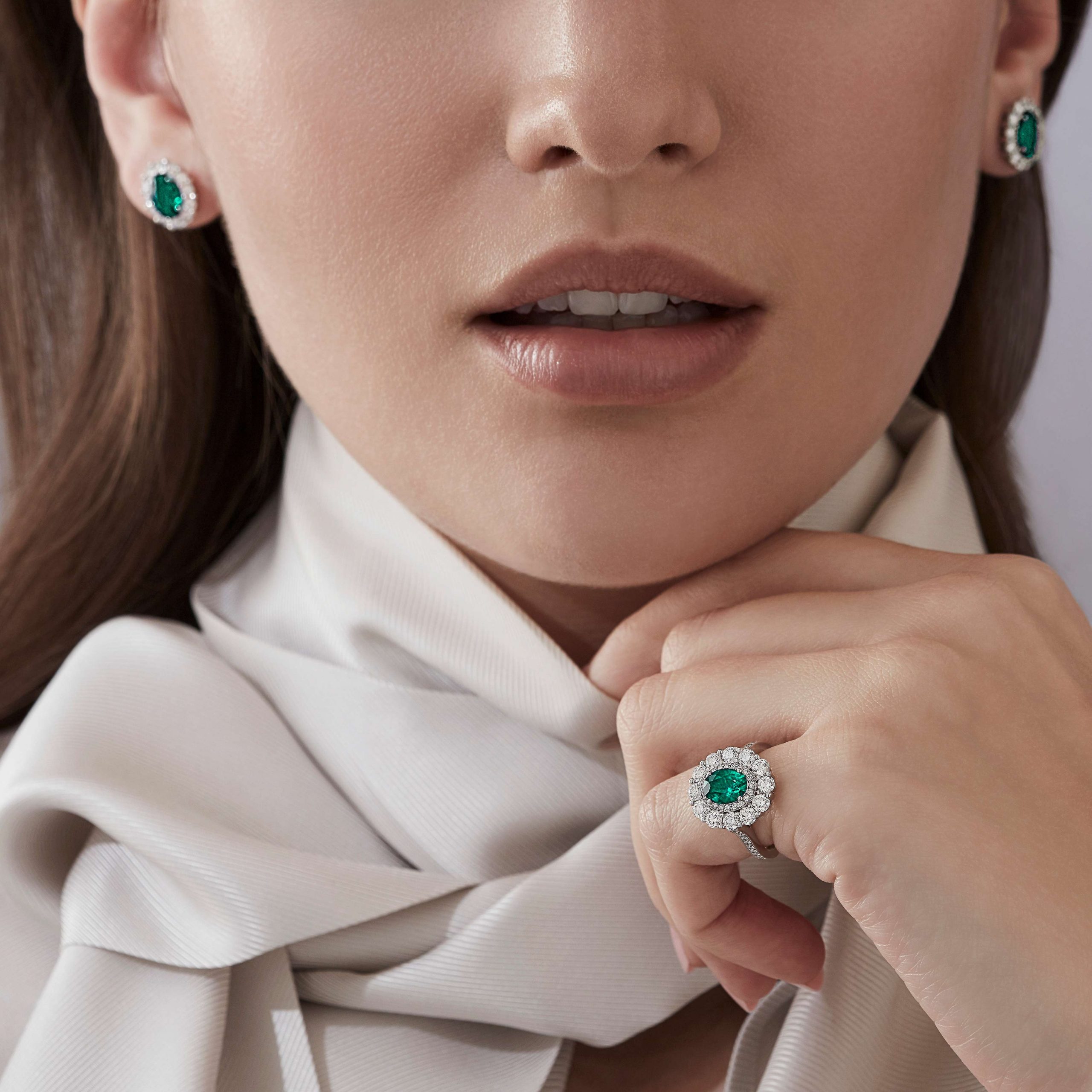 Garrard 1735 jewellery collection Emerald Oval Double Cluster Ring In Platinium with Diamonds JR17PT07 and earrings On Model Garrard 1735 jewellery collection Emerald Oval Double Cluster Ring In Platinium with Diamonds JR17PT07 and earrings On Model