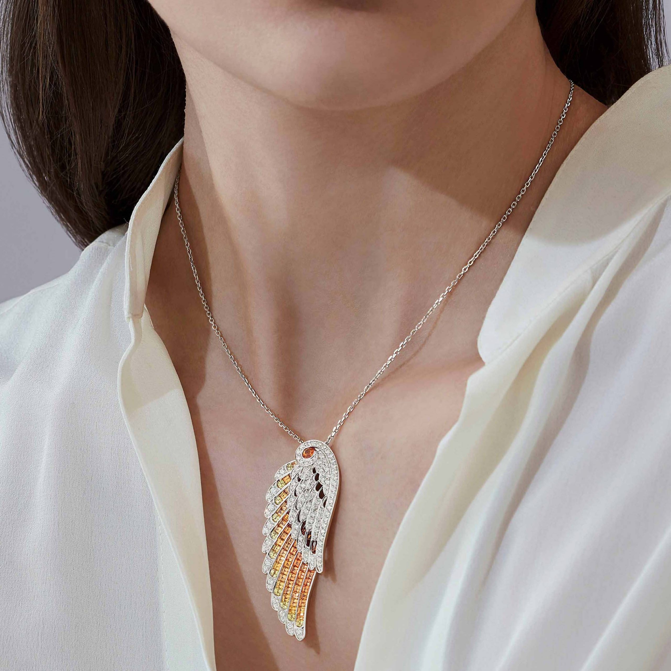 Garrard Wings Embrace jewellery collection Phoenix Slider Pendant In 18ct White Gold with Diamonds Sapphires 2017607 and earrings On Model 1 Garrard Wings Embrace jewellery collection Phoenix Slider Pendant In 18ct White Gold with Diamonds Sapphires 2017607 and earrings On Model 1
