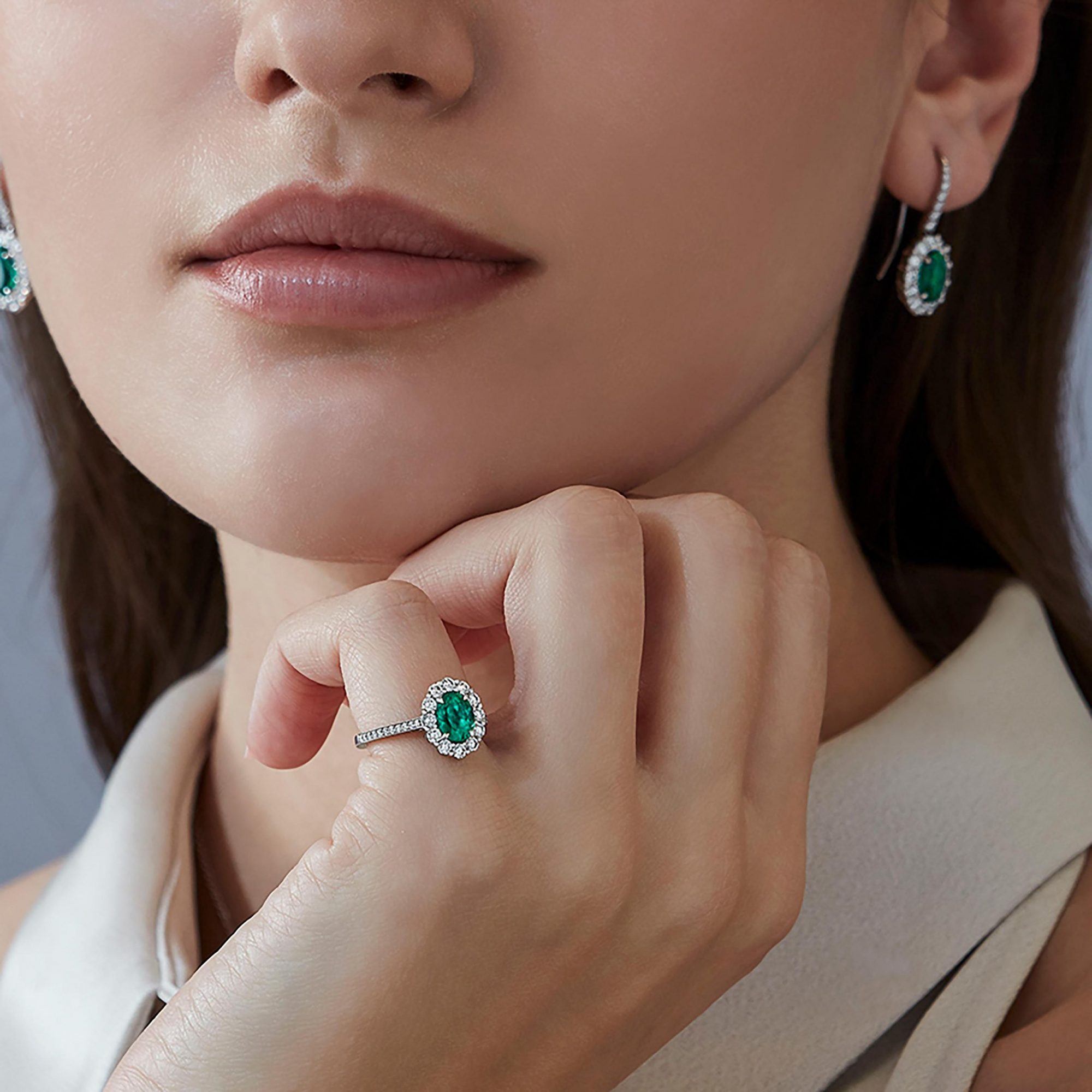 Garrard 1735 jewellery Emerald Oval Ring in Platinum with diamonds JR17PT01 and earrings On Model 1 scaled 1